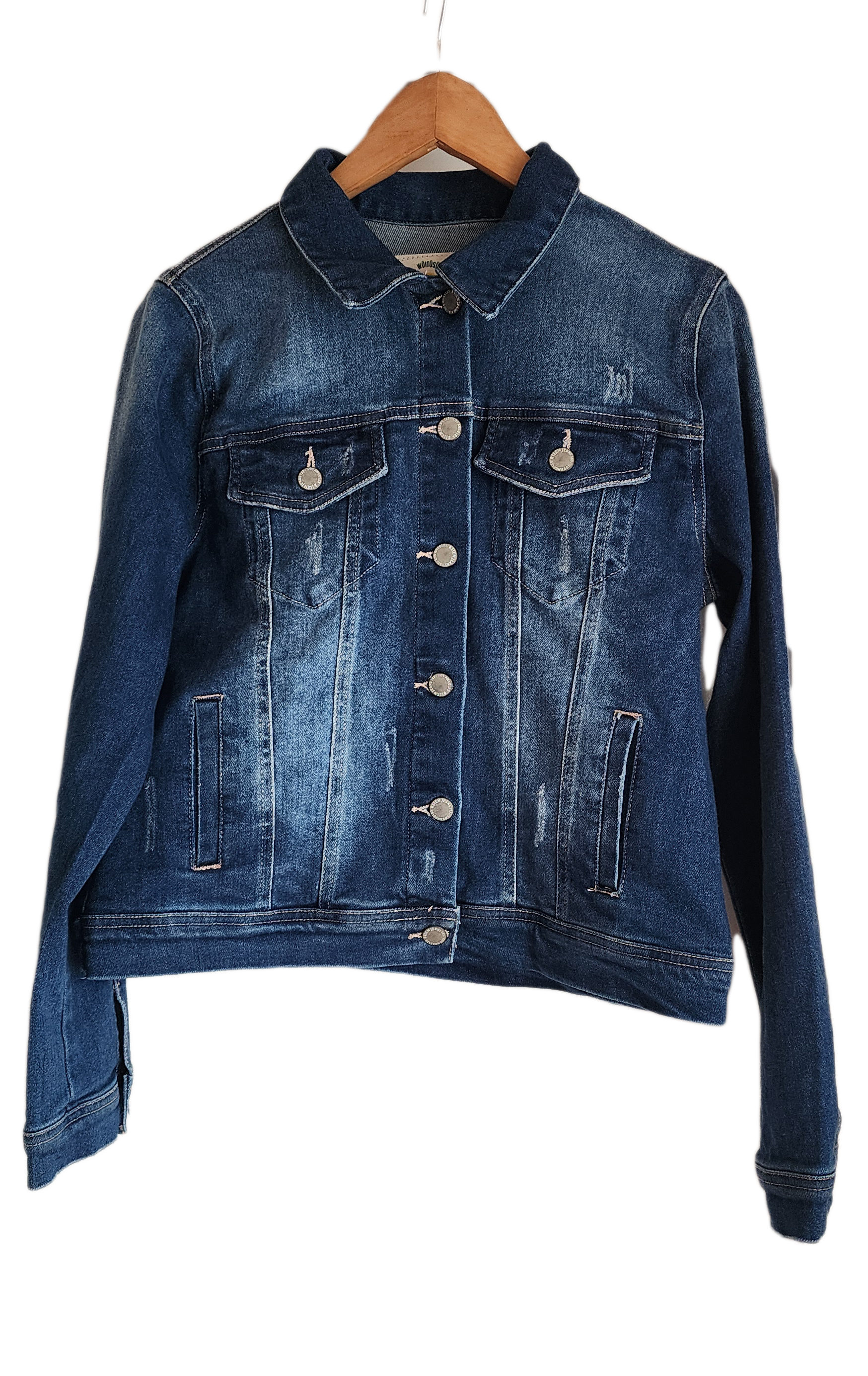 "Handmade denim jacket with colorful Wayuu-inspired punch needle embroidery on the back, showcasing unique artisan craftsmans