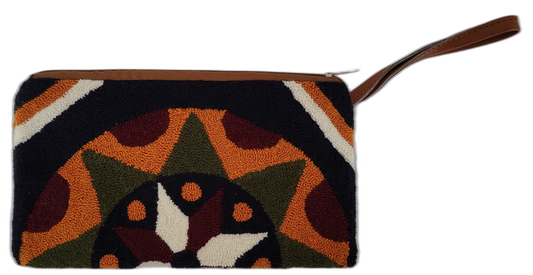 Handmade Wayuu clutch featuring bold earth tones and geometric punch needle design

