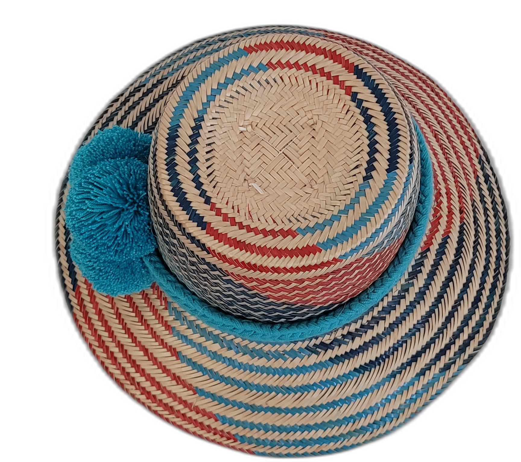 Artisan Wayuu hat, a handmade bohemian straw hat with colorful design and large decorative pompoms.

