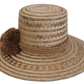 Handmade artisan Wayuu straw hat featuring brown pompoms.

