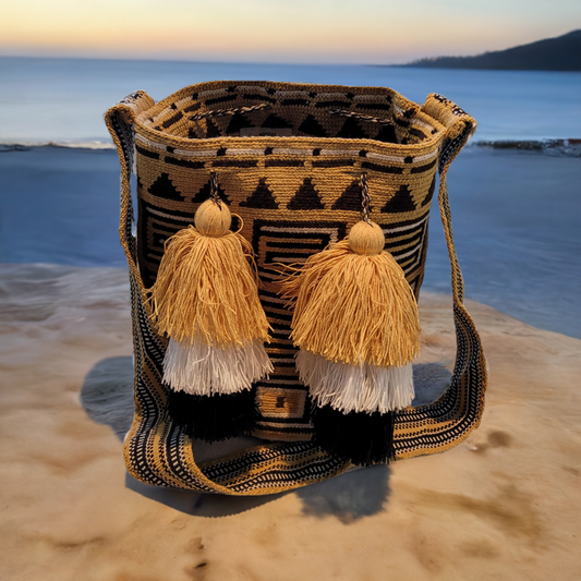 "Handmade Paleteada Crochet Wayuu Bag by Wuitusu artisans, featuring vibrant, geometric designs and metallic threading."