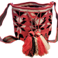"Handmade Paleteada Crochet Wayuu Bag with colorful geometric patterns, crafted by the Wayuu tribes, featuring a versatile st