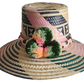 "Handmade, vibrant Wayuu hat crafted from Iraca palm fibers with culturally significant pompoms and adjustable fit."