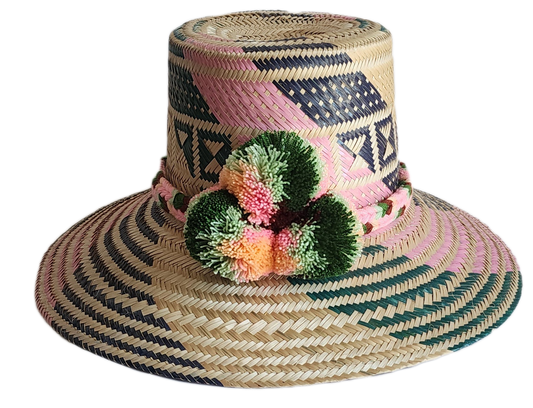 "Handmade, vibrant Wayuu hat crafted from Iraca palm fibers with culturally significant pompoms and adjustable fit."