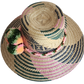 "Handmade, vibrant Wayuu hat crafted from Iraca palm fibers with culturally significant pompoms and adjustable fit."