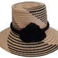 Handmade Wayuu black-and-natural straw hat with elegant black pompoms.


