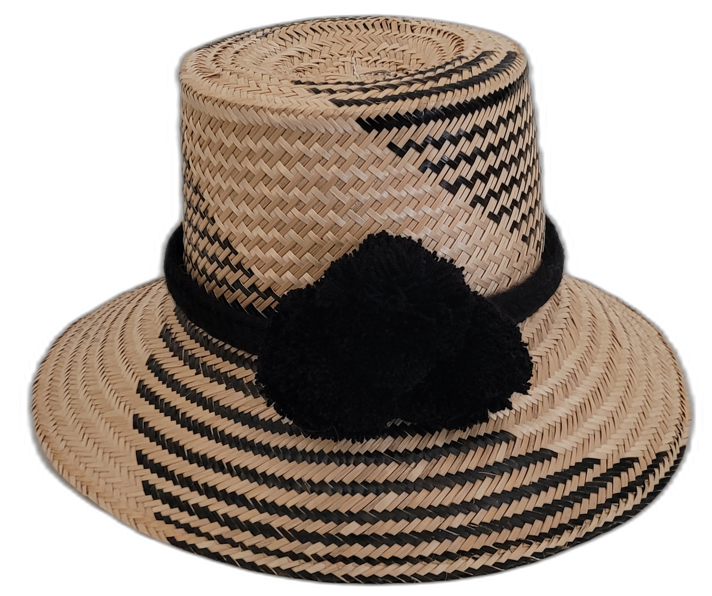 Handmade Wayuu black-and-natural straw hat with elegant black pompoms.

