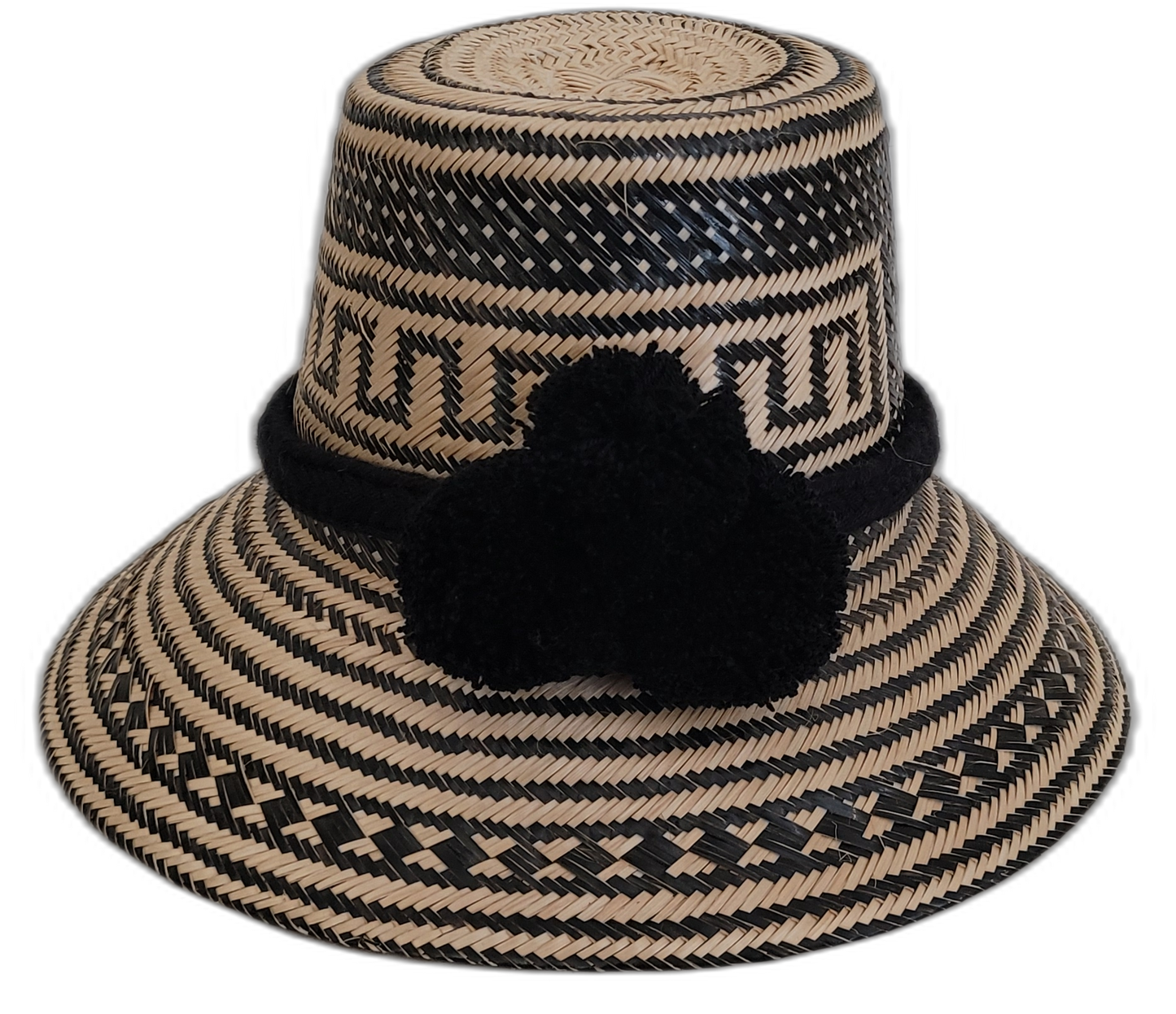 Handmade black Wayuu straw hat with matching black pompoms, artisan woven.

