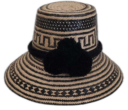 Handmade black Wayuu straw hat with matching black pompoms, artisan woven.


