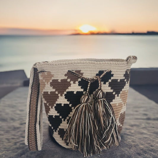 Handmade Wayuu bag in earthy tones with black and beige tassels