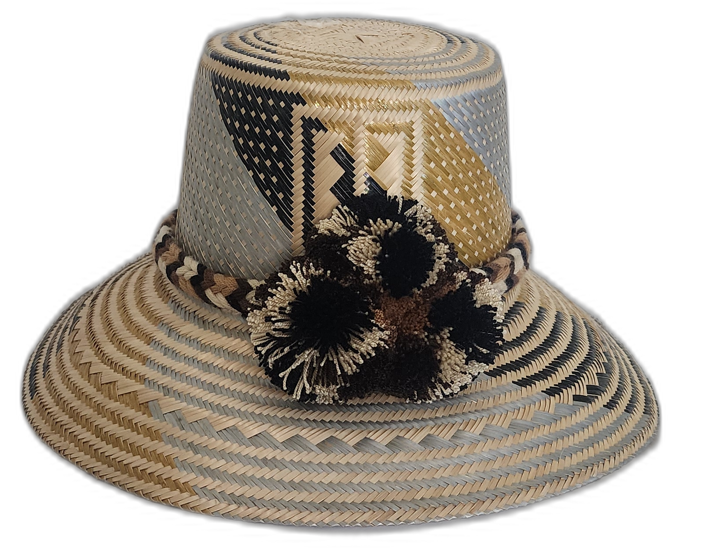 Handmade Wayuu straw hat with black and beige pompoms and geometric neutral design.Boho Wayuu hat with earth-toned colorblocking and cultural pattern
