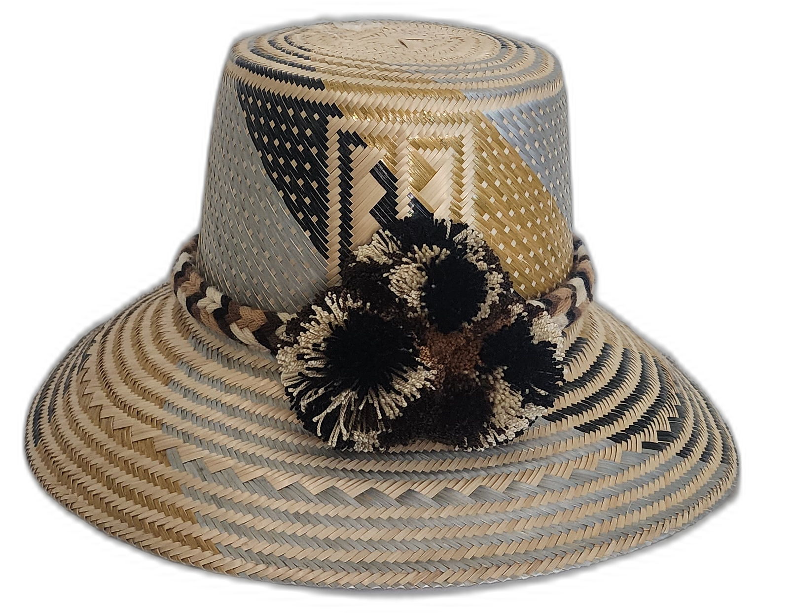Handmade Wayuu straw hat with black and beige pompoms and geometric neutral design.Boho Wayuu hat with earth-toned colorblocking and cultural pattern
