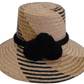 Handmade Wayuu boho straw hat with black pompoms and artisan weave.

