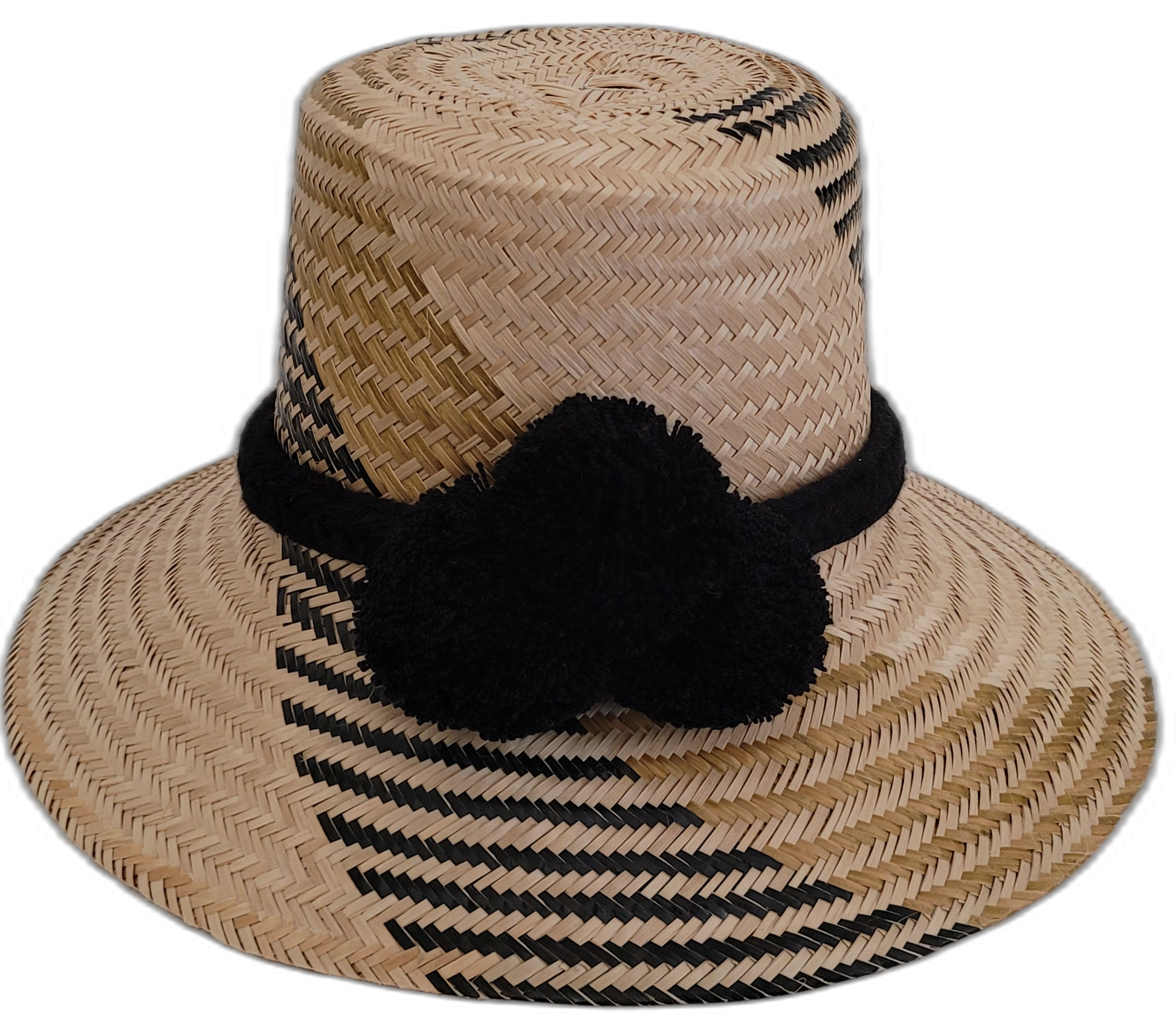 Handmade Wayuu boho straw hat with black pompoms and artisan weave.

