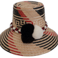 Handmade Wayuu bohemian straw hat with black and white pompoms and red accents.

