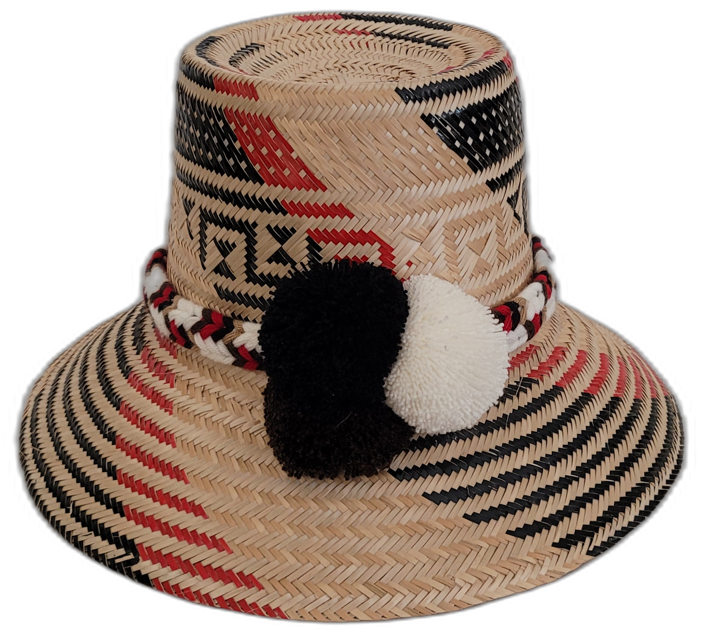 Handmade Wayuu bohemian straw hat with black and white pompoms and red accents.

