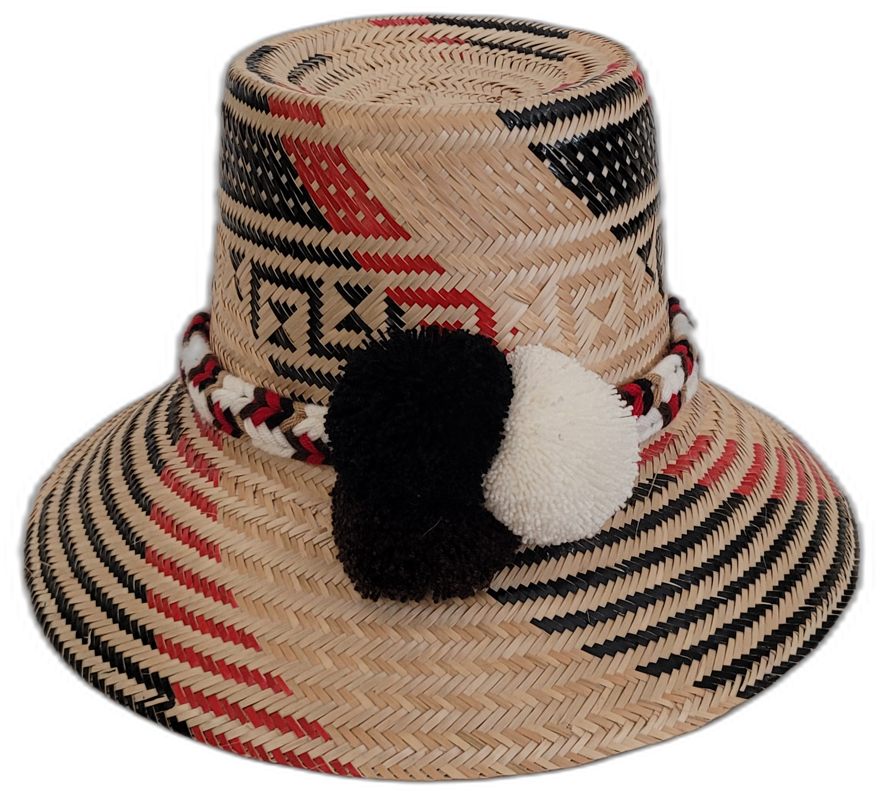 Handmade Wayuu bohemian straw hat with black and white pompoms and red accents.

