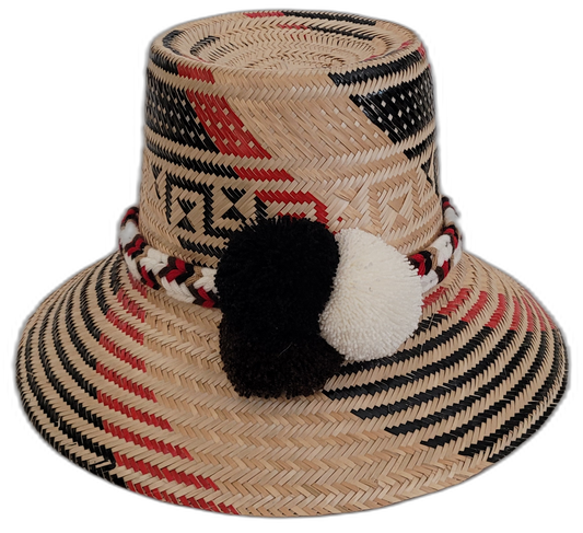 Handmade Wayuu bohemian straw hat with black and white pompoms and red accents.

