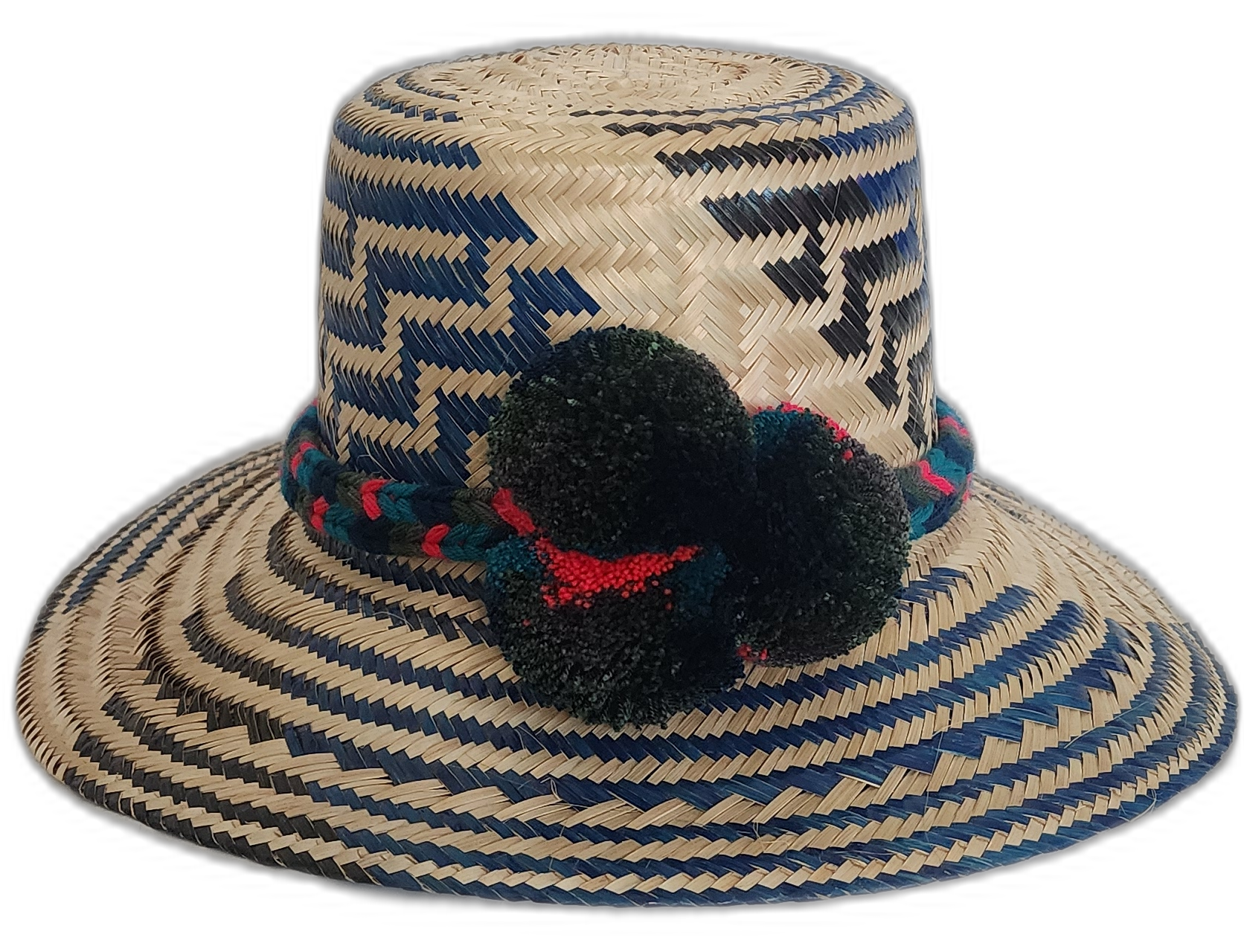 Handmade Wayuu straw hat with navy and black weave and dark green and red pompoms.Boho Wayuu hat featuring zigzag designs and handcrafted pompoms



