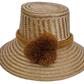 Handmade Wayuu boho straw hat with golden-brown pompoms and artisan weave.

