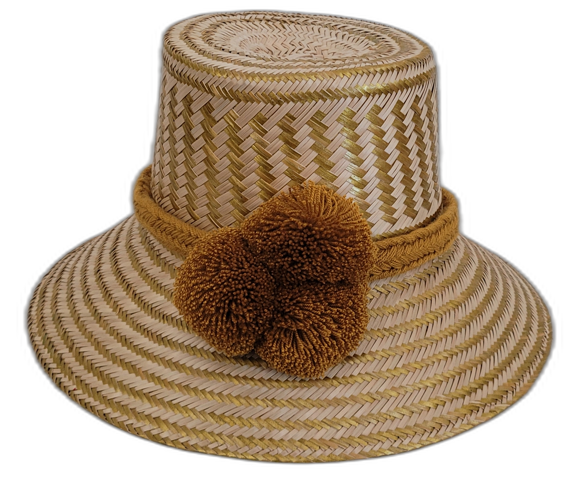 Handmade Wayuu boho straw hat with golden-brown pompoms and artisan weave.

