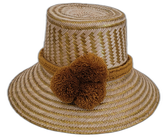 Handmade Wayuu boho straw hat with golden-brown pompoms and artisan weave.

