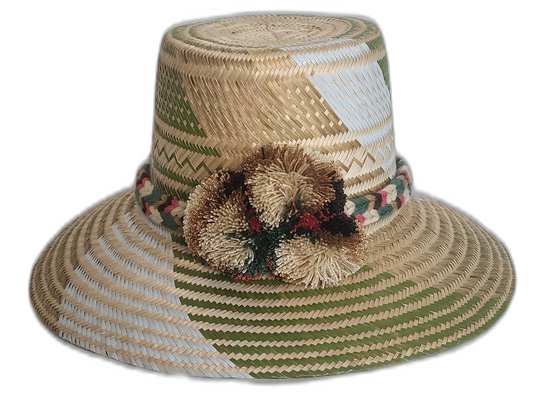 Handmade Wayuu straw hat with green and cream woven pattern and natural-tone pompoms.