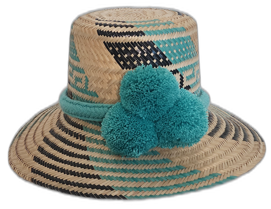 Handmade Wayuu boho straw hat with turquoise pompoms and bold black weave patterns.