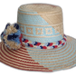 Boho chick straw hat featuring bright pompoms and artisan detail