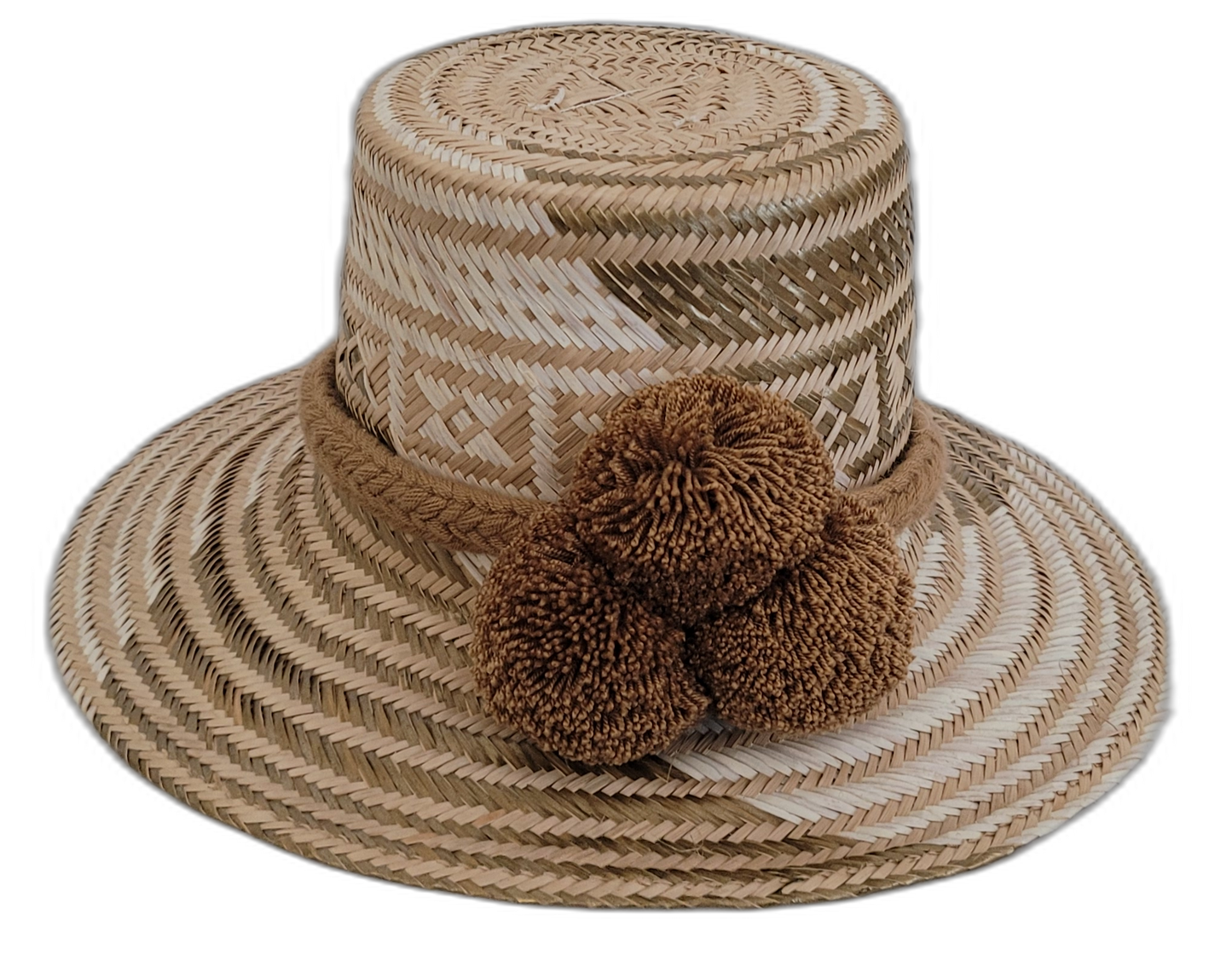 Handmade Wayuu straw hat with earthy brown tones and matching brown pompoms.

