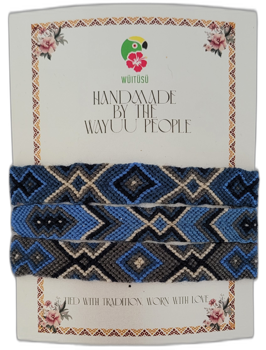 Handmade Wayuu friendship bracelet featuring blue, black, gray, and cream — a beautiful Boho chic accessory with tribal patterns and artisan tradition.