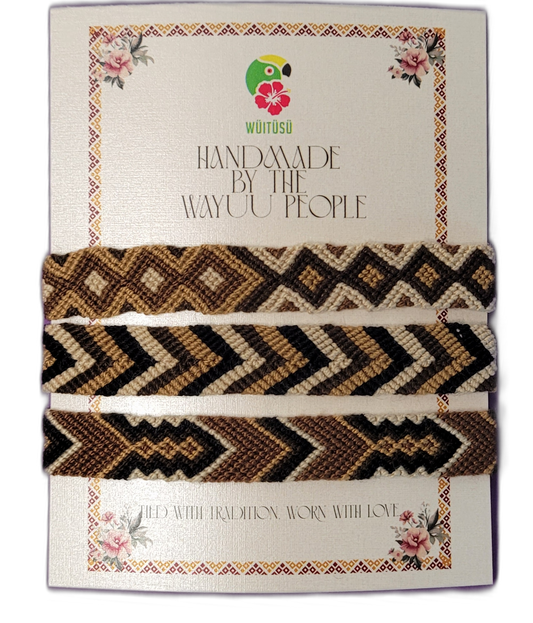 Handmade Wayuu friendship bracelets in black, brown, tan, and cream with tribal geometric patterns

