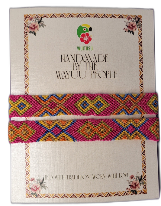Handmade Wayuu friendship bracelets in pink, yellow, orange, and blue with vibrant tribal patterns

