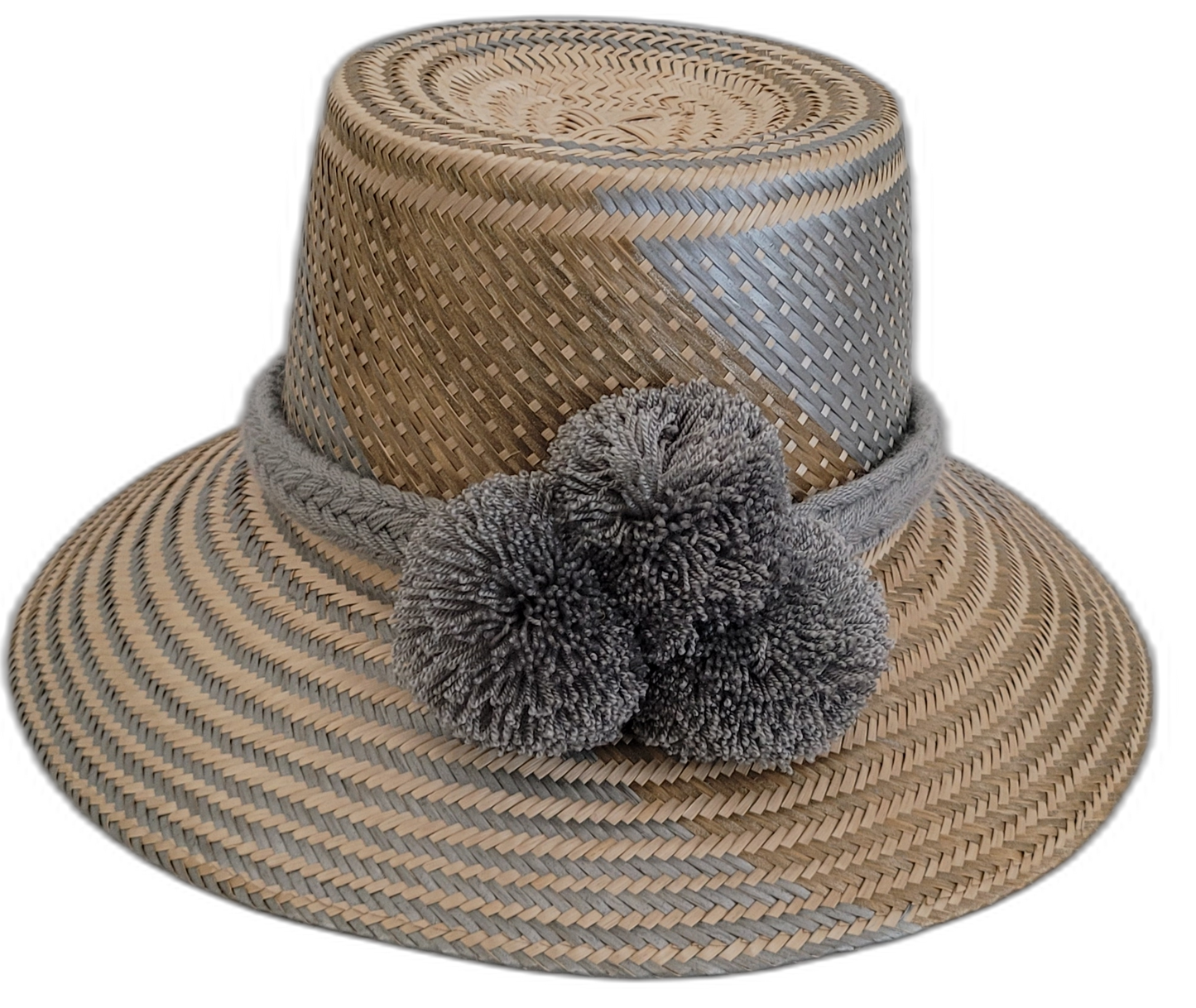Handmade Wayuu straw hat with soft gray accents and matching gray pompoms.

