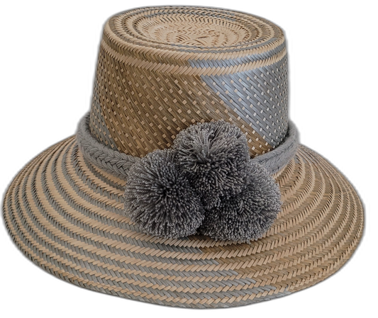 Handmade Wayuu straw hat with soft gray accents and matching gray pompoms.

