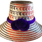 "Handmade Wayuu hat crafted from iraca palm fibers, featuring vibrant colors and intricate patterns by Wuitusu artisans."