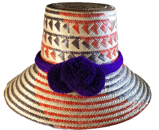 Artisan-crafted straw hat featuring red, black, and natural weave with purple pompom band