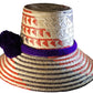 "Handmade Wayuu hat crafted from iraca palm fibers, featuring vibrant colors and intricate patterns by Wuitusu artisans."