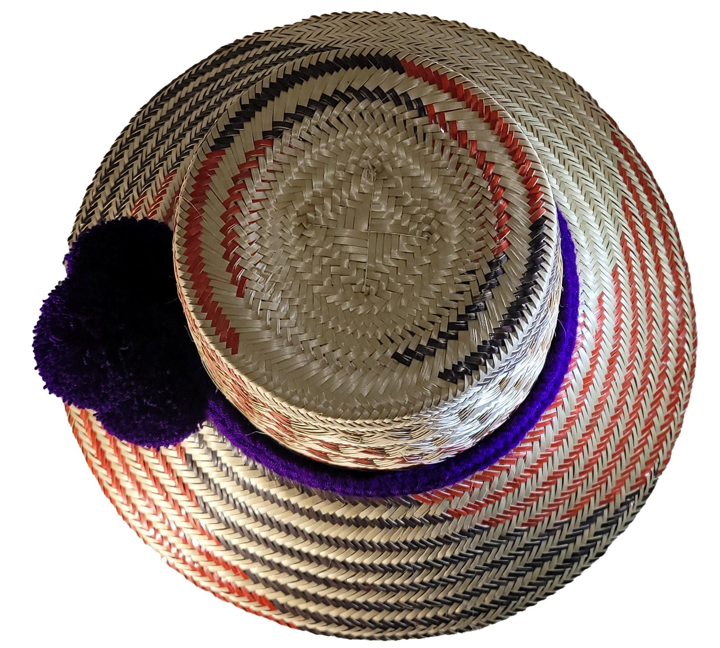 "Handmade Wayuu hat crafted from iraca palm fibers, featuring vibrant colors and intricate patterns by Wuitusu artisans."