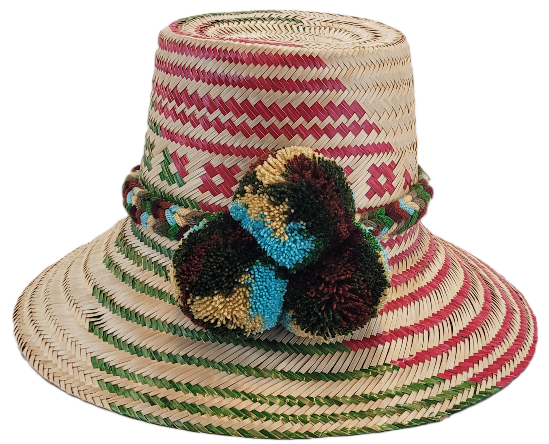 "Handmade Wayuu hat crafted from Iraca palm fibers with colorful pompoms, representing the Wayuu tribe's heritage."