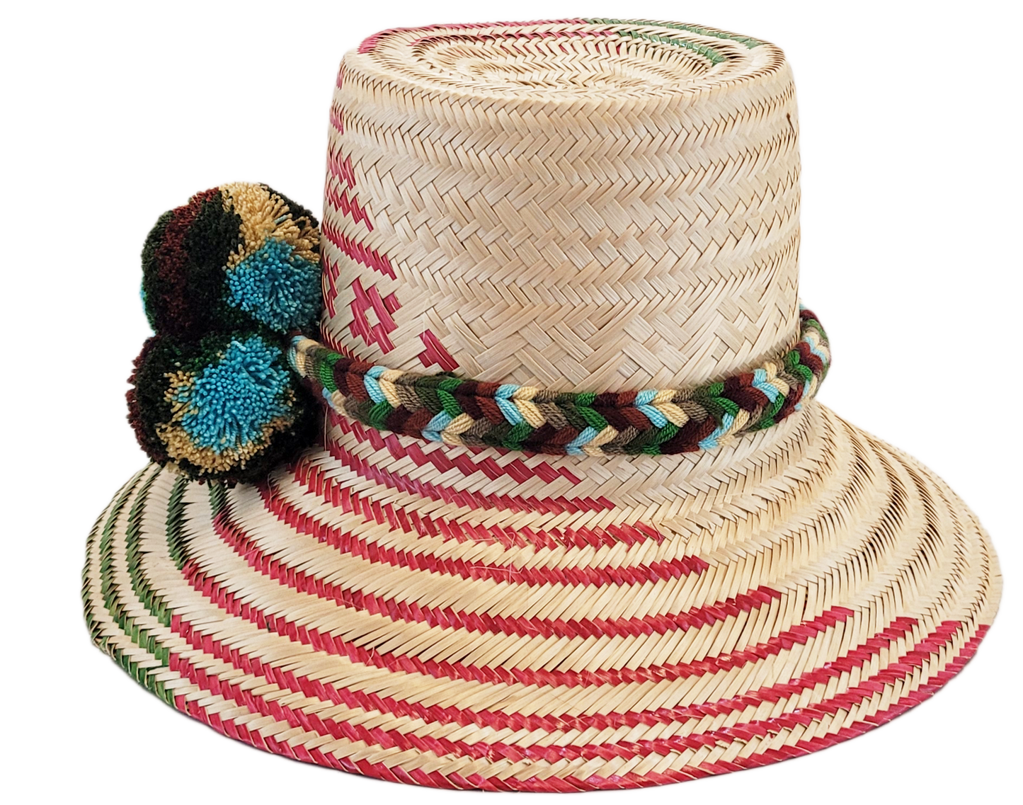 "Handmade Wayuu hat crafted from Iraca palm fibers with colorful pompoms, representing the Wayuu tribe's heritage."