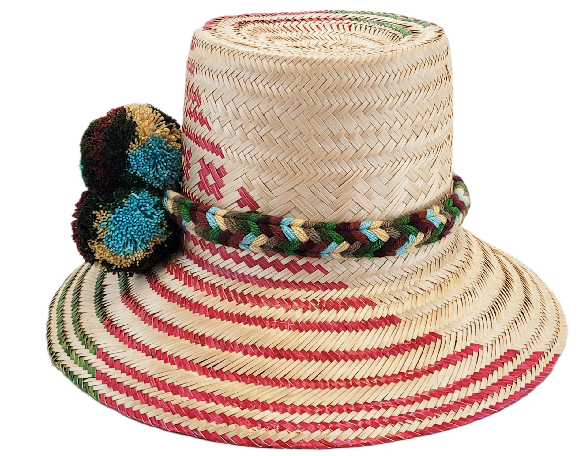 "Handmade Wayuu hat crafted from Iraca palm fibers with colorful pompoms, representing the Wayuu tribe's heritage."