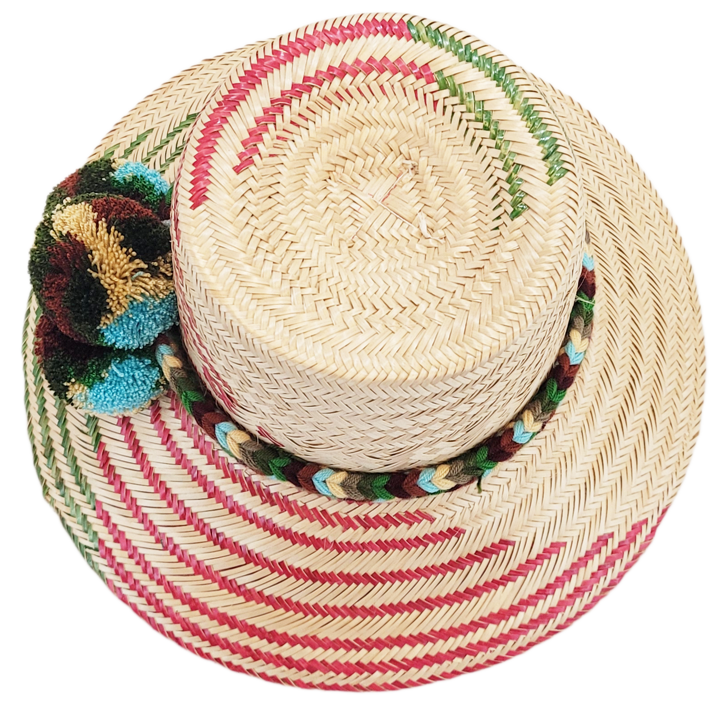 "Handmade Wayuu hat crafted from Iraca palm fibers with colorful pompoms, representing the Wayuu tribe's heritage."
