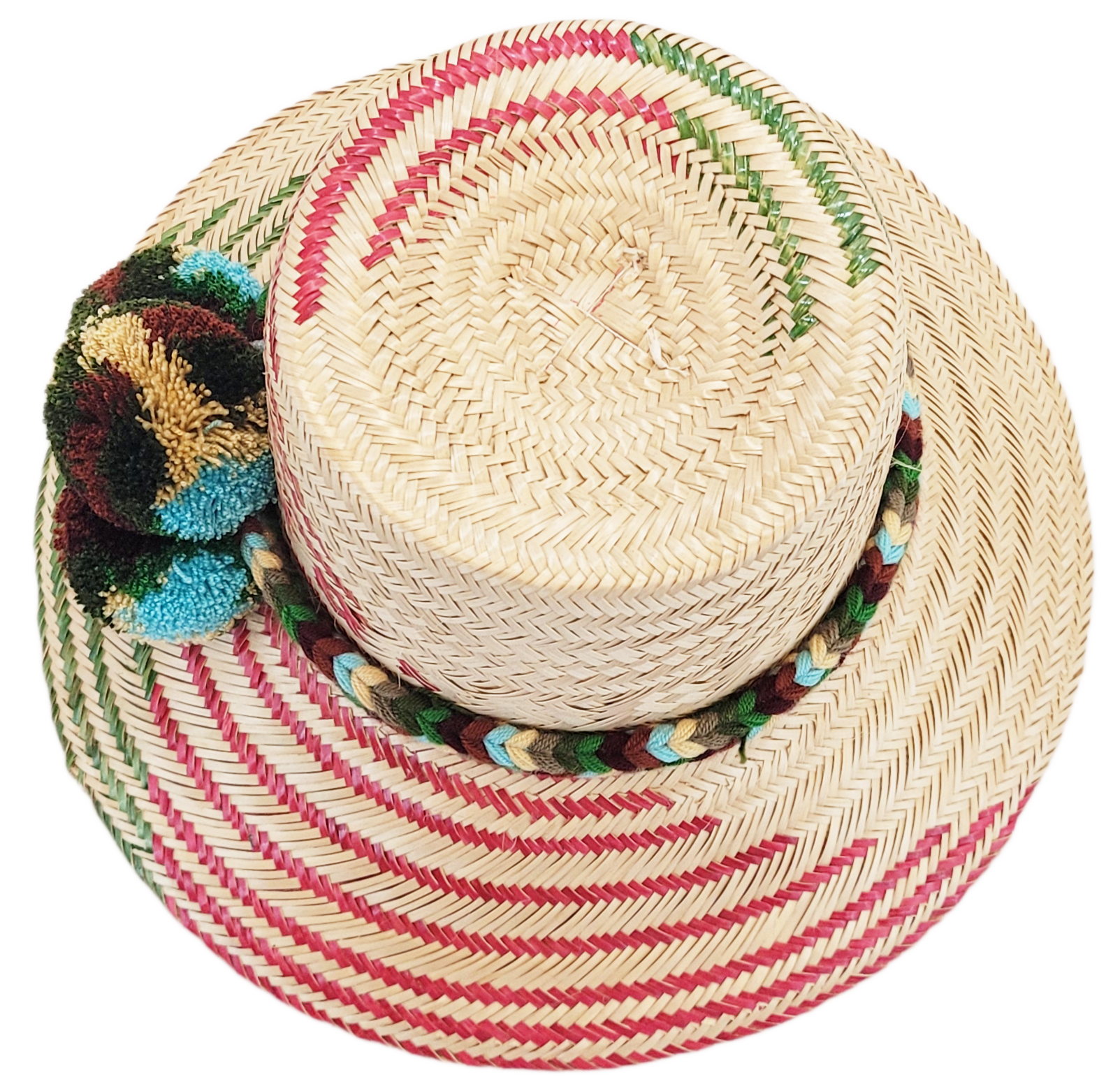"Handmade Wayuu hat crafted from Iraca palm fibers with colorful pompoms, representing the Wayuu tribe's heritage."