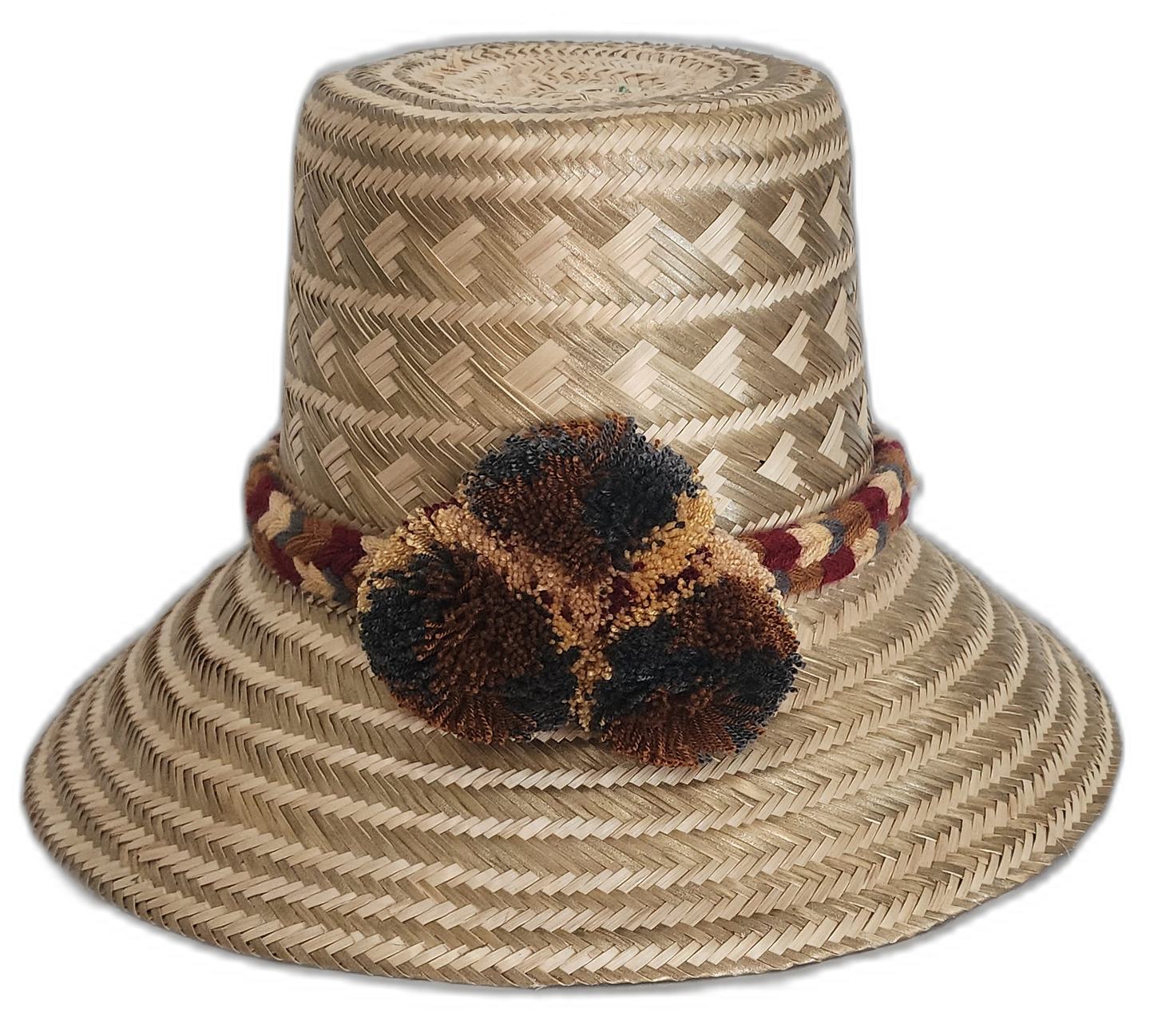 Handmade Wayuu straw hat with earth-tone weave and dark pompoms