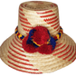 "Handmade Wayuu hat from Iraca palm fibers, adorned with culturally significant pompoms, adjustable size for various styles."