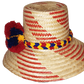 "Handmade Wayuu hat from Iraca palm fibers, adorned with culturally significant pompoms, adjustable size for various styles."
