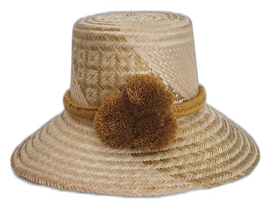 Handmade Wayuu straw hat with neutral tribal design and golden pompoms