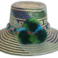 Handmade Wayuu straw hat with blue and green tribal patterns and pompoms