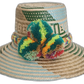 Handmade Wayuu straw hat with green and blue patterns and multicolor pompoms